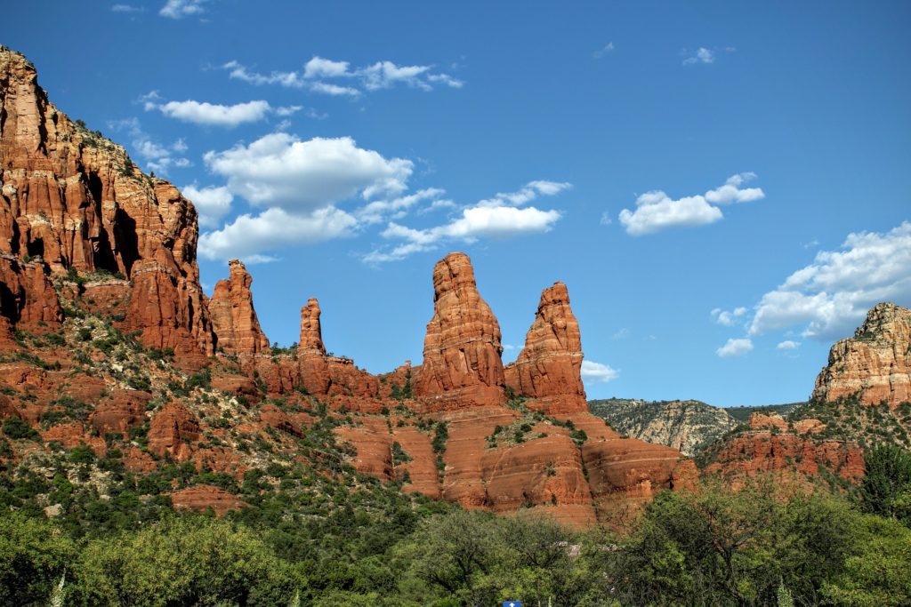 Red rock formations and greenery under a clear blue sky in Sedona, Arizona, reminiscent of the tranquility one might find during hypnotherapy in San Mateo, CA.